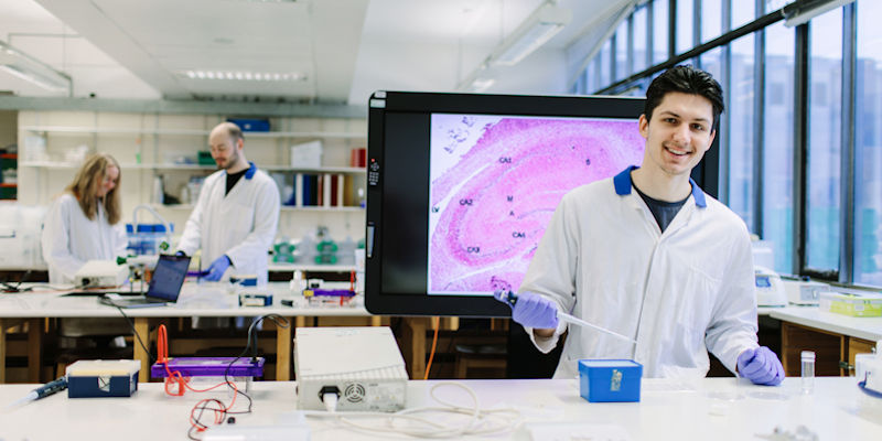 A student conducting an experiment in a lab at the University.