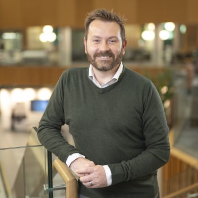 Professor Andrew Macdonald smiles at the camera