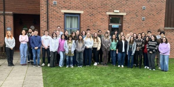 Large group of PhD students standing outside the accommodation at the YBDTP residential November 2025