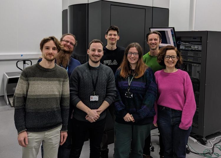 The EM facility team stood in front of the Krios microscope