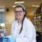 PhD student Grace Roberts sat in a science lab at the University of Leeds.